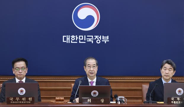 South Korean acting President Han Duck-soo, center, speaks during a Cabinet meeting at the government complex in Seoul.