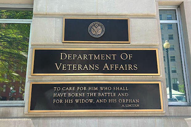 A sign outside the Department of Veterans Affairs headquarters features Abraham Lincoln's words