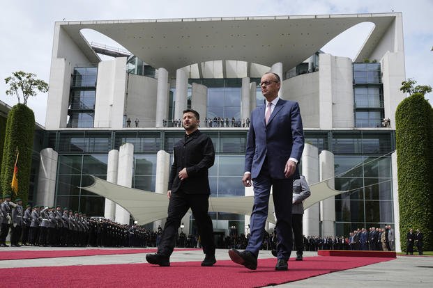 Germany's Chancellor Friedrich Merz, right, welcomes Ukraine's President Volodymyr Zelenskyy