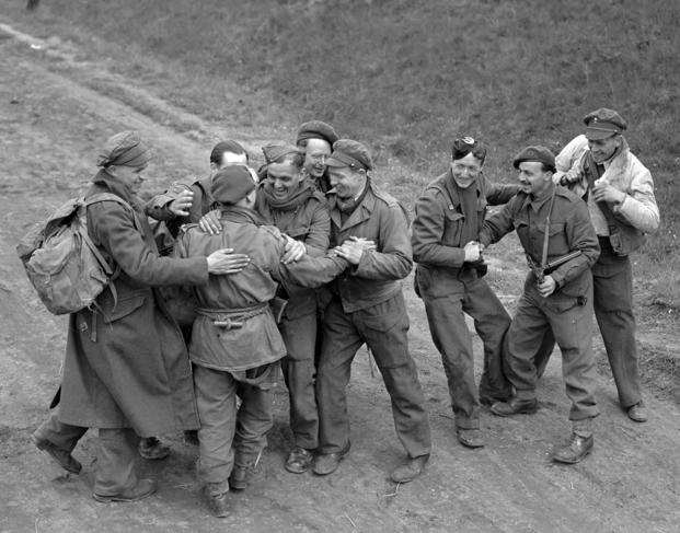  Recently released British prisoners of war meet up with a parachute recce party while marching towards Allied lines