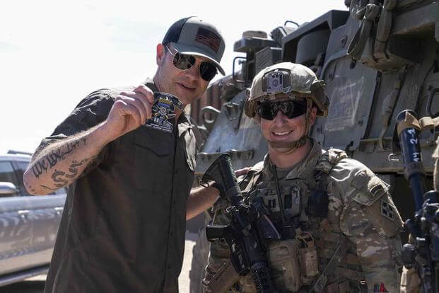 Secretary of Defense Pete Hegseth receives a coin 