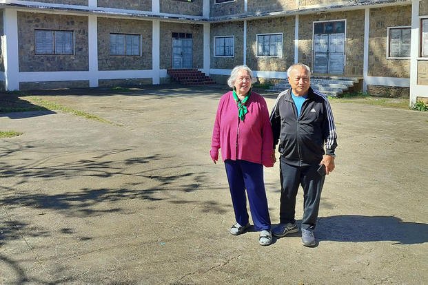 Mayka and Kao Xiong stand in front of General Vang Pao’s old house