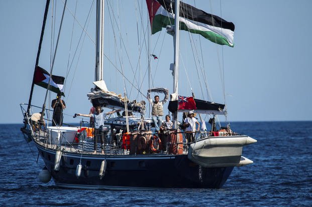 Activists of the Freedom Flotilla Coalition, board the Madleen boat, ahead of setting sail for Gaza, departing from the Sicilian port of Catania, Italy
