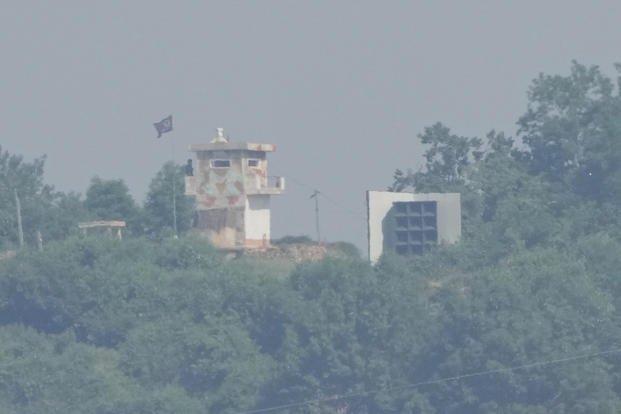 A North Korean military guard post, left, and loudspeaker are seen from Paju, South Korea, near the border with North Korea