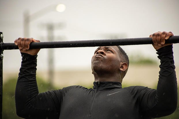 U.S. Marine Corps Sgt. Keyon A. Simmons-Harwell conducts a pull-up during a battalion workout challenge at Camp Elmore, Norfolk, Virginia.
