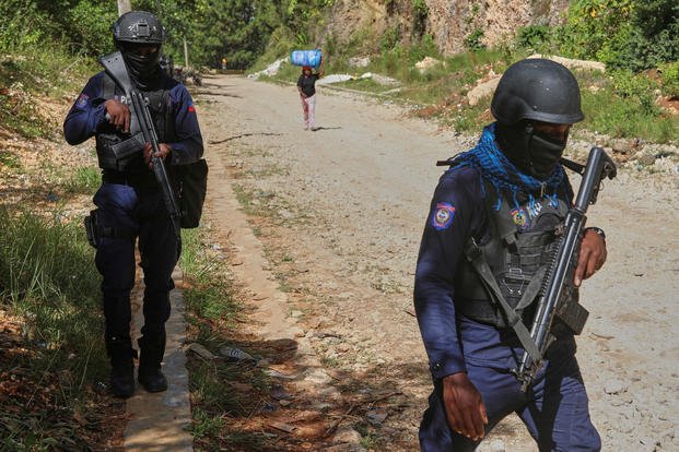 Police officers patrol the area near the Saint-Helene orphanage in the Kenscoff neighborhood of Port-au-Prince, Haiti