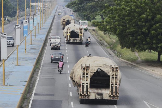 Trucks transport tanks east from Valencia, Venezuela