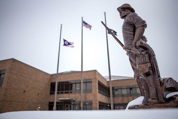 The minuteman statue in front of the headquarters building following a snow storm