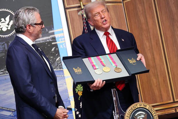 Donald Trump displays a set of 1984 Los Angeles Olympic medals