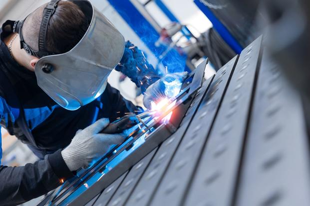 A person welds.