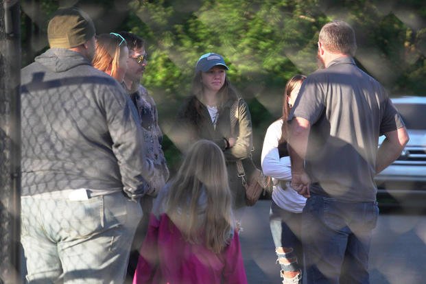 Family members gather outside of an explosive plant after a blast.
