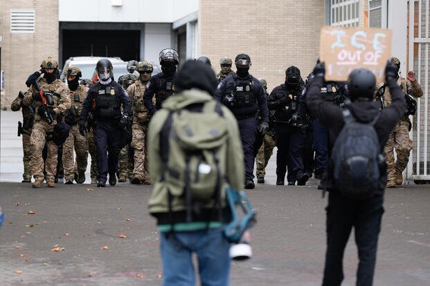 People protest outside a U.S. Immigration and Customs Enforcement facility.
