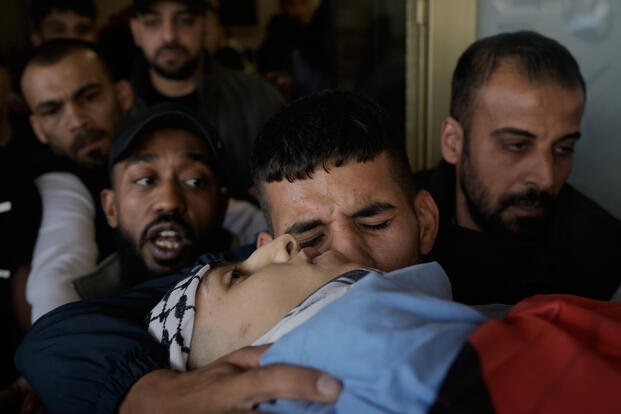 Palestinians mourn during a funeral.
