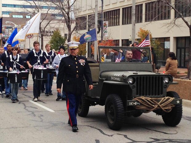 Kansas Highway Patrol Superintendent Ernie Garcia, a Marine Corps veteran, walks in a Veterans Day parade, Monday, Nov. 11, 2013, in downtown Topeka, Kan.  (AP Photo/John Milburn)