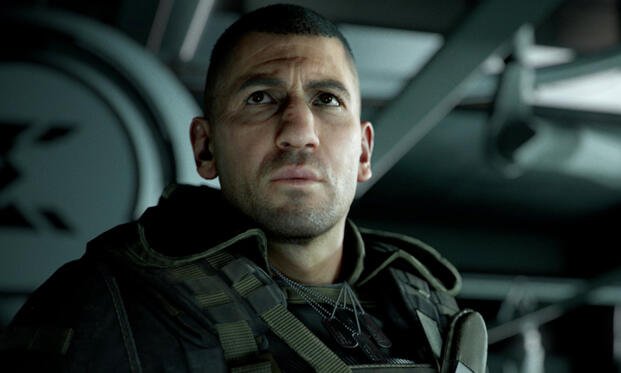 Close-up in-game render of a stern-faced soldier in tactical gear and dog tags inside an aircraft, portraying antagonist Cole D. Walker from Ghost Recon: Breakpoint.