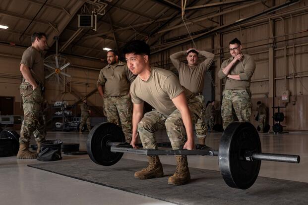 An airman performs a deadlift.