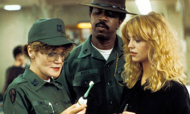 Private Benjamin (1980) – Capt. Doreen Lewis (Eileen Brennan) inspects gear with Sgt. L.C. Ross (Hal Williams) as Judy Benjamin (Goldie Hawn) looks on. Credit: Warner Bros. Pictures.