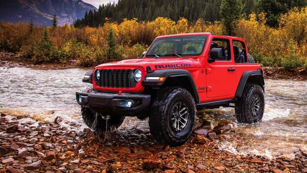 2025 Jeep Wrangler Rubicon in red parked off-road