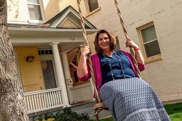 Nicole in front of her house