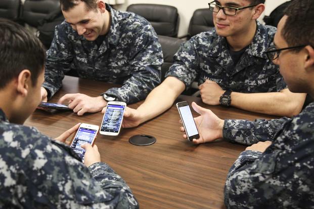 Sailors looking at phones