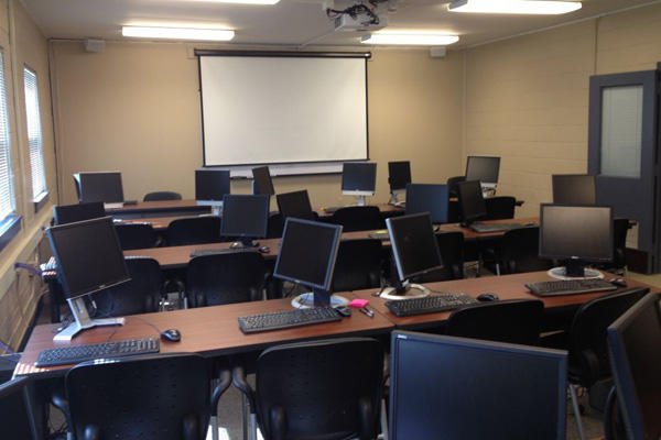 Empty classroom computer screens.