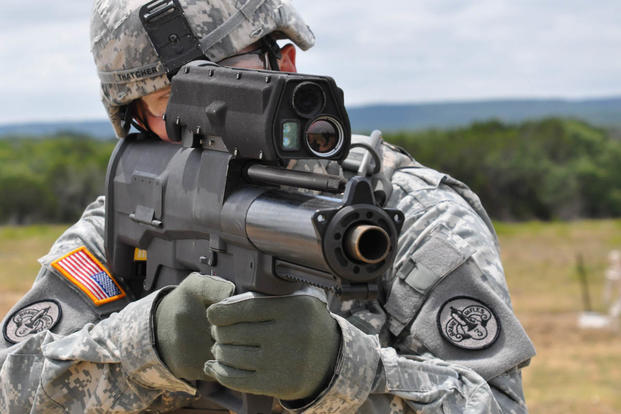 A soldier aims an XM25 Counter Defilade Target Engagement weapon system at Aberdeen Test Center, Md. Army photo