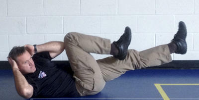 Stew Smith demonstrating bicycle crunches.