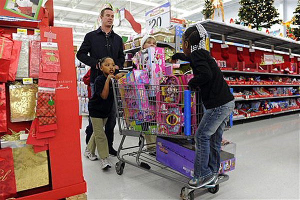 Atlanta Falcons quarterback Matt Ryan helps children push a cart of toys while he and teammates participated in the "Shop with a Jock" program, which provides a $100 gift card and a shopping experience to children from an Atlanta-area mission.
