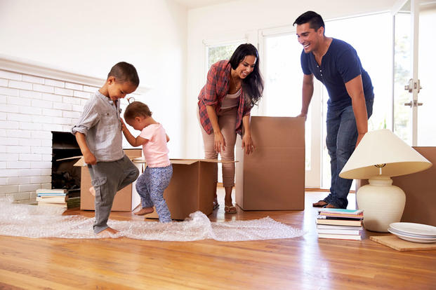 A family with moving boxes in their new home