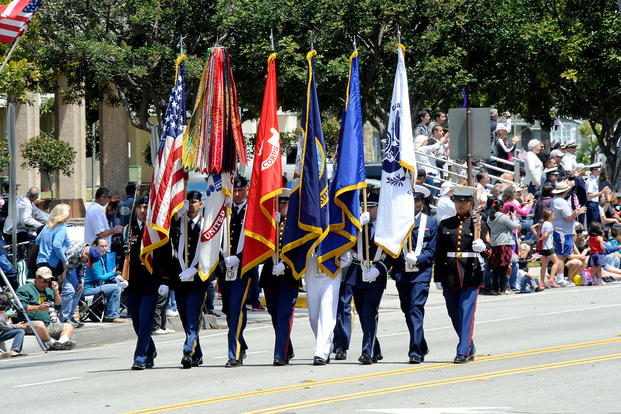 A joint services color guard leads off an annual Armed Forces Day parade (Photo: U.S. Air Force/Joe Juarez.)