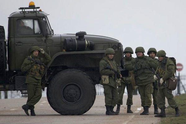 Unidentified gunmen wearing camouflage uniforms block the road toward the military airport at the Black Sea port of Sevastopol in Crimea, Ukraine, Feb. 28, 2014. (AP Photo/Ivan Sekretarev)
