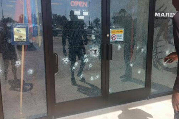 Bullet holes in the entrance to the Chattanooga military recruiting center (Photo: April Grimmett via Twitter)
