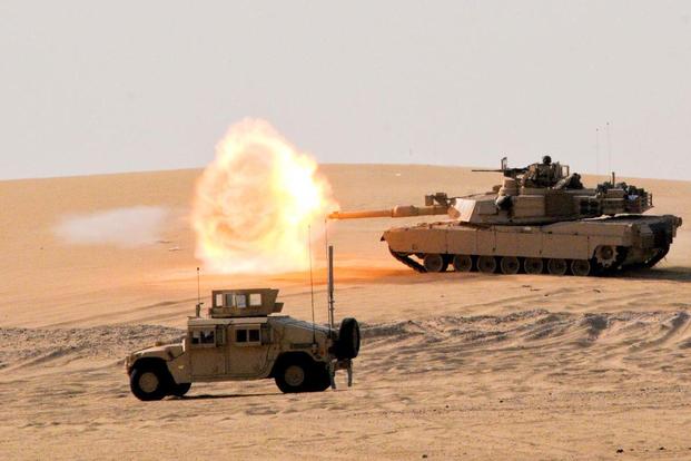 An M1A2 Abrams main battle tank crew engages a target during the 3rd ABCT field training exercise at Udairi Range Complex, Kuwait, Aug. 5, 2015. (Photo: U.S. Army)