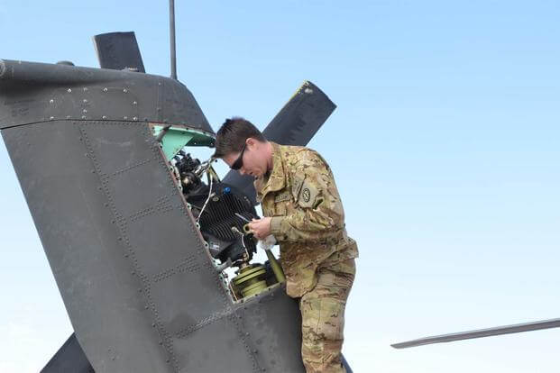Sgt. Tiara Carr, an Apache maintainer with Company C, 1st Battalion, 135th Aviation Regiment (Attack Reconnaissance), Missouri National Guard, inspects the tail rotor gear box Nov. 5, 2013. (U.S. Army/Cpt. Andrew Cochran)