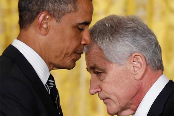 In this Jan. 7, 2013 file photo, President Barack Obama, left, and former U.S. Sen. Chuck Hagel, R-Neb., walk past each other during a new conference in the East Room of the White House