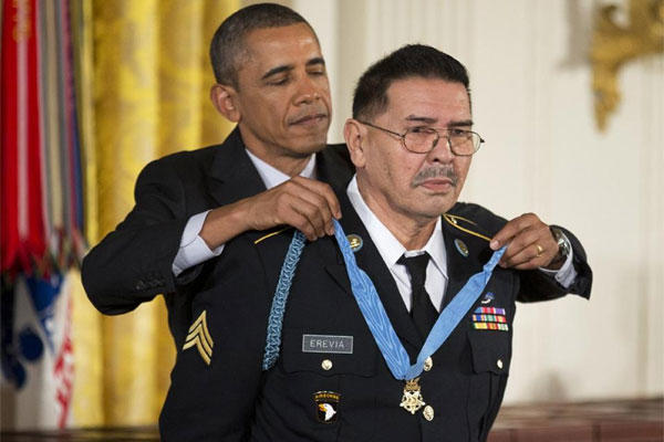 President Barack Obama awards Army Spc. Santiago Erevia the Medal of Honor during a ceremony in the East Room of the White House in Washington, Tuesday, March 18, 2014. (AP Photo/Manuel Balce Ceneta)