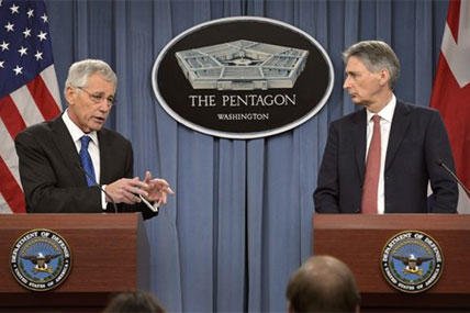 U.S. Defense Secretary Chuck Hagel, left, and British Defense Secretary Philip Hammond brief reporters during a joint news conference at the Pentagon, March 26, 2014. DOD photo by Glenn Fawcett