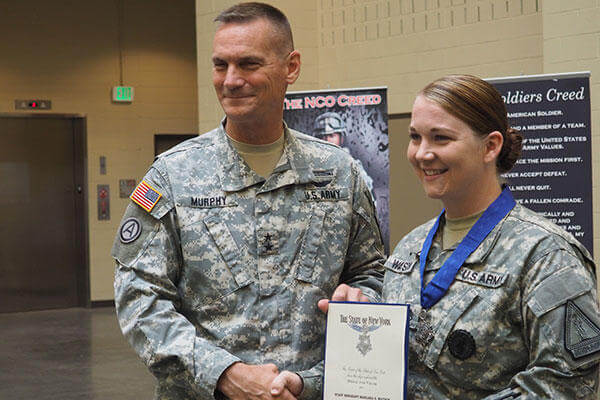 New York Army National Guard Major Gen. Patrick Murphy presents the New York State Medal for Valor to Staff Sgt. Marlana Watson. (U.S. Army/Sgt. J.P. Lawrence)