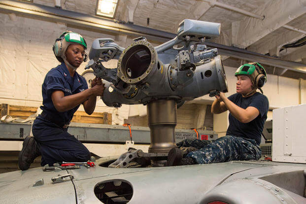 Aviation Electrician's Mate 2nd Class Etoryia Anderson and Dakota Flint inspect the main rotor head of an MH-60R helicopter attached to HSM 35. (U.S. Navy photo by Mass Communication Specialist 2nd Class Joe Bishop)