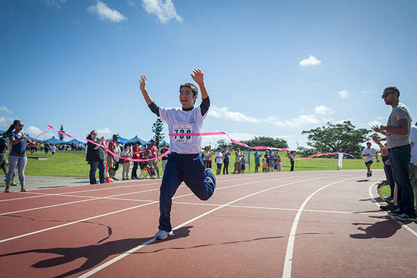 Kohei Setake, a Kadena Special Olympics athlete, wins first place in a 200-meter dash during the Kadena Special Olympics Nov. 7, 2015, at Kadena Air Base, Japan. (U.S. Air Force/A1C Lynette M. Rolen)