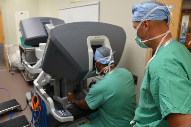 Maj. George Kallingal showcases a robotic surgical system while Lt. Col. Thomas Novak, Brooke Army Medical Center's chief of pediatric urology, looks on at San Antonio Military Medical Center in San Antonio, July 6, 2015. (Photo: Robert T. Shields)