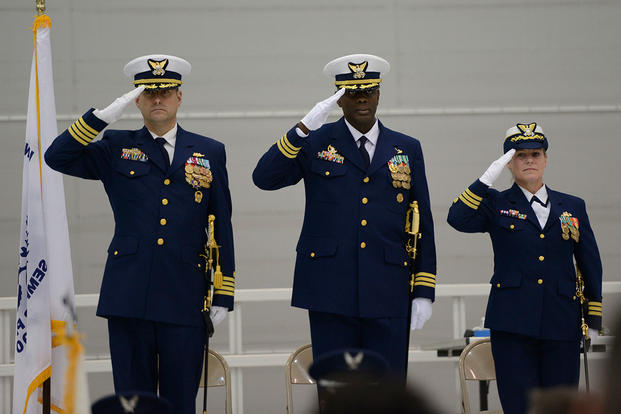 Capt. Joeseph Hester, Cmdr. Ronzelle Green and Cmdr. Nan Silverman-Wise render salutes during the presentation of colors at the Coast Guard Port Security Unit 308 change of command ceremony, Dec. 5, 2015. (Photo: Petty Officer 2nd Class Ryan Tippets)