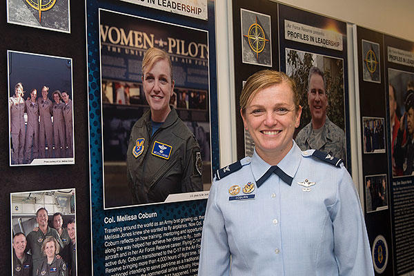 Col. Melissa Coburn stands next to her profile during the unveiling of the Profiles in Leadership display in the Pentagon, Washington, D.C. (U.S. Air Force/Jim Varhegyi)