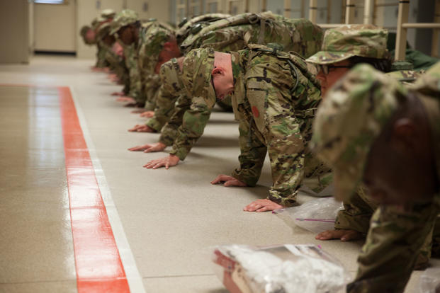 U.S. Army Trainees assigned to Foxtrot 1st Battalion 34th Infantry Regiment conduct push-ups for corrective training in the barracks on the first day of Basic Combat Training on June 12, 2017 at Fort Jackson, SC. (U.S. Army photo/Sgt. Philip McTaggart)
