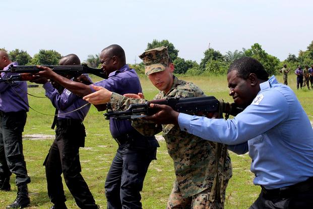 U.S. Marines and U.K. Royal Marine Commandos teach Nigerian sailors weapons handling skills and marksmanship, Oct. 22, in Sekondi, Ghana. Photo By: Navy Lt j.g. Jason Bond