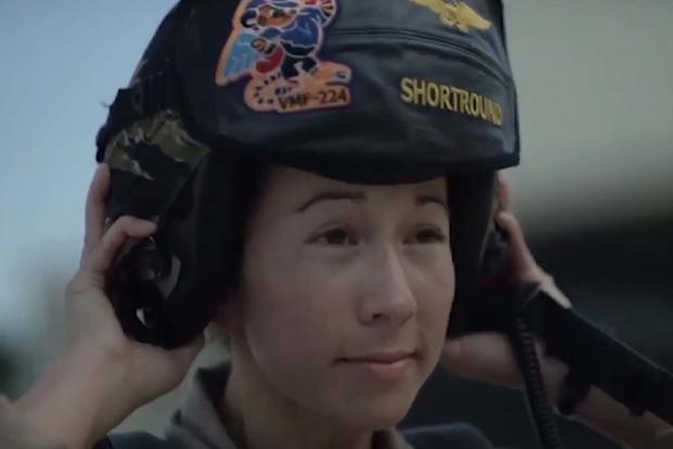 Image of a female Marine putting on her helmet from the motivational video “Marines: We Have to Win" (Screengrab of Marine Video)