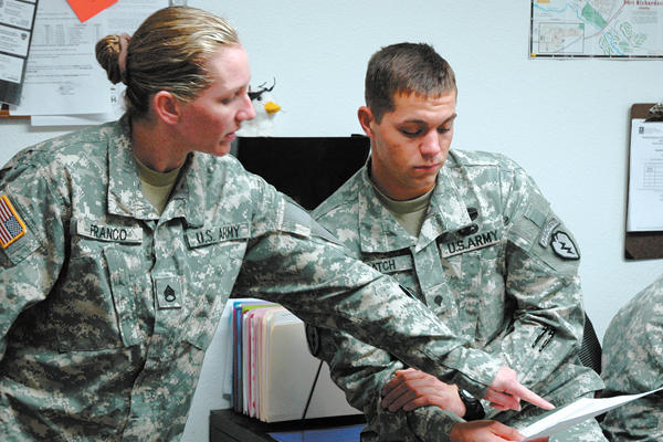 Army soldiers plan with a document.