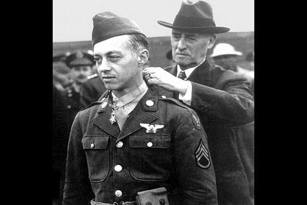 Sergeant Maynard H. Smith, a en:B-17 Flying Fortress gunner, receiving the first Medal of Honor to be awarded to an enlisted man from United States Secretary of War Henry L. Stimson. (U.S. Air Force photo)
