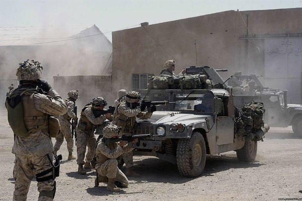 U.S. Marines from 1st Battalion, 5th Marines fire at insurgent positions during the First Battle of Fallujah in April-May 2004. (U.S. Marine Corps/Matthew Apprendi)