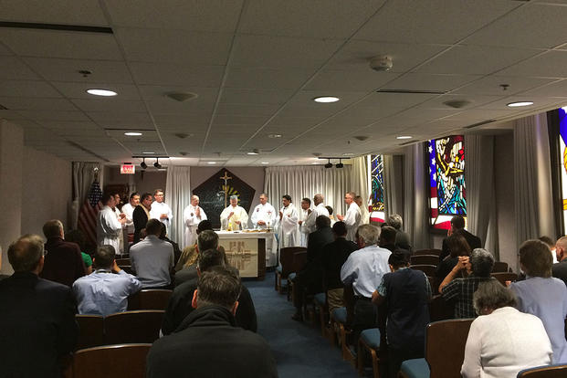 Ten Catholic priests who spent the week visiting Washington-area military bases to learn about being chaplains participate in a Mass on Thursday at the 9/11 Memorial Chapel at the Pentagon. Photo by Bryant Jordan/Military.com